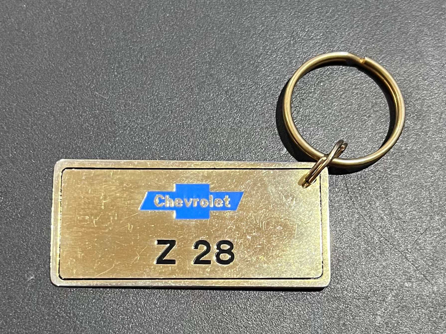 Chevrolet Z 28 Gold Plated Metal Keychain with Engravable Backside NOS Relic has been store safely away for decades and shows some wear but vintage from the 1980s
