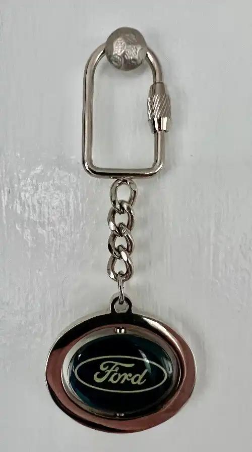 Ford Keychain Tradition Logo Spinning Center Accessories N.O.S. Item Ford logo spinning Center keychain with lock. Mint, never used and stored away for decades.