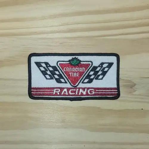 Canadian Tire Racing Patch Cross Flags Auto Rectangle N.O.S. Rare. This relic has been stored for decades and the oval measure 2 inch wide and the length is 4 inch