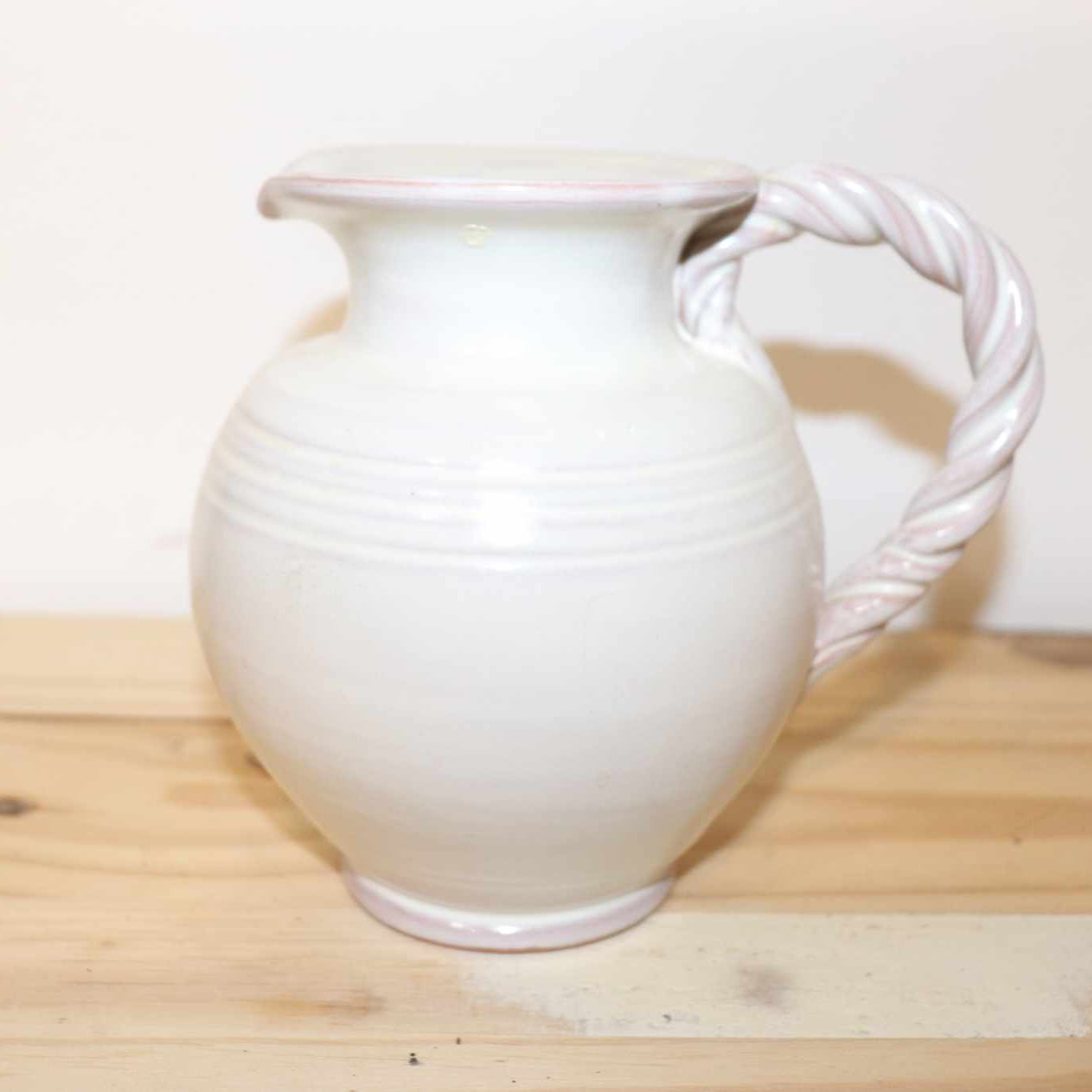 Gilde Handwerk Pottery Pitcher, vintage stoneware item. Great detail, twisted handle, and cream color