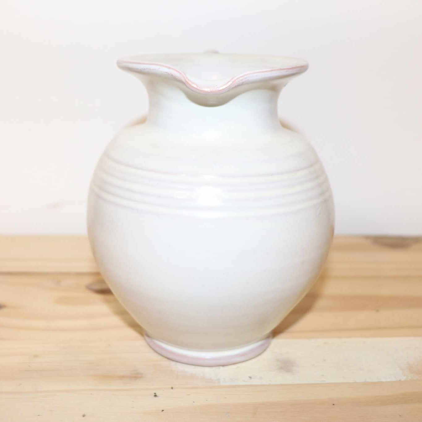 Gilde Handwerk Pottery Pitcher, vintage stoneware item. Great detail, twisted handle, and cream color