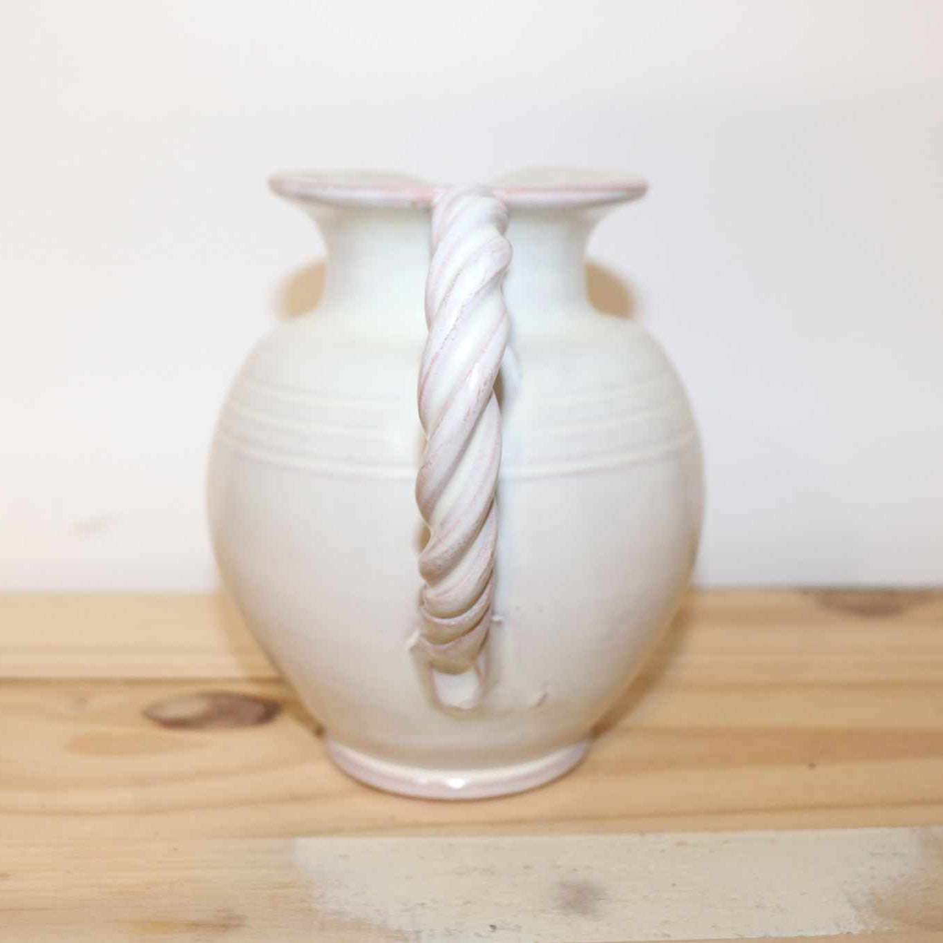 Gilde Handwerk Pottery Pitcher, vintage stoneware item. Great detail, twisted handle, and cream color