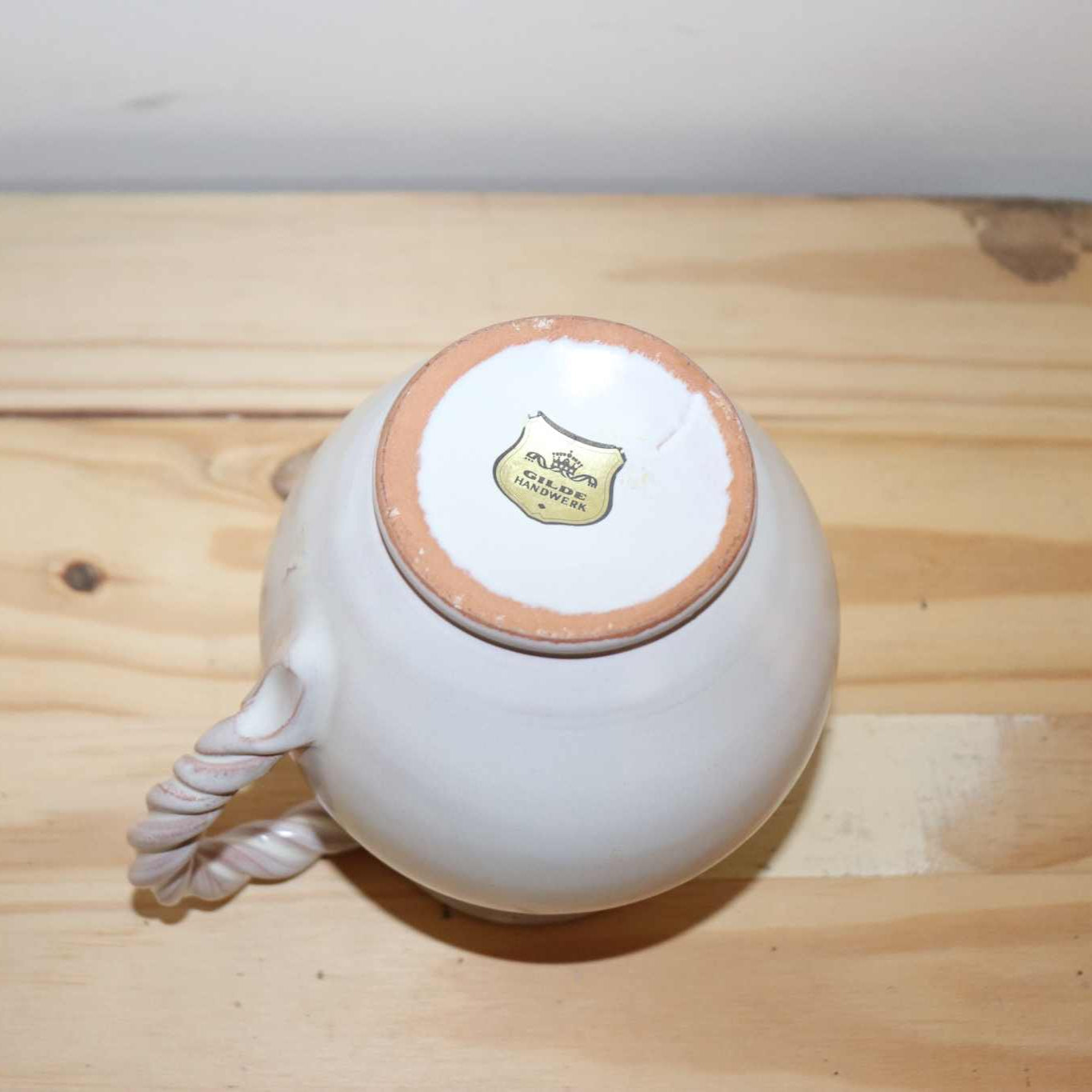 Gilde Handwerk Pottery Pitcher, vintage stoneware item. Great detail, twisted handle, and cream color
