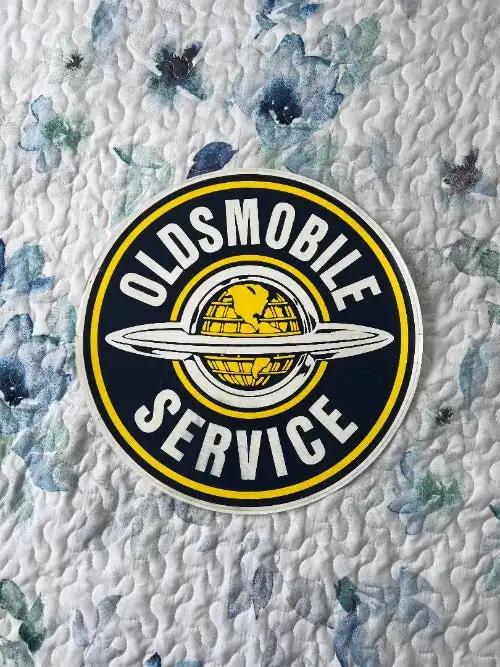 Oldsmobile DECAL Global World SERVICE LARGE MINT NOS ITEM Classic LOOK. This is an approx 12 inch circle Oldsmobile SERVICE decal.  Crest logo centered, great detail