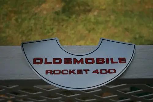 OLDSMOBILE ROCKET 400 DECAL AIR CLEANER LID MINT New Old Stock Item.  Decal measuring 10 1/2 x 3 1/2 inches.  Red lettering on a silver backing, mint condition! 